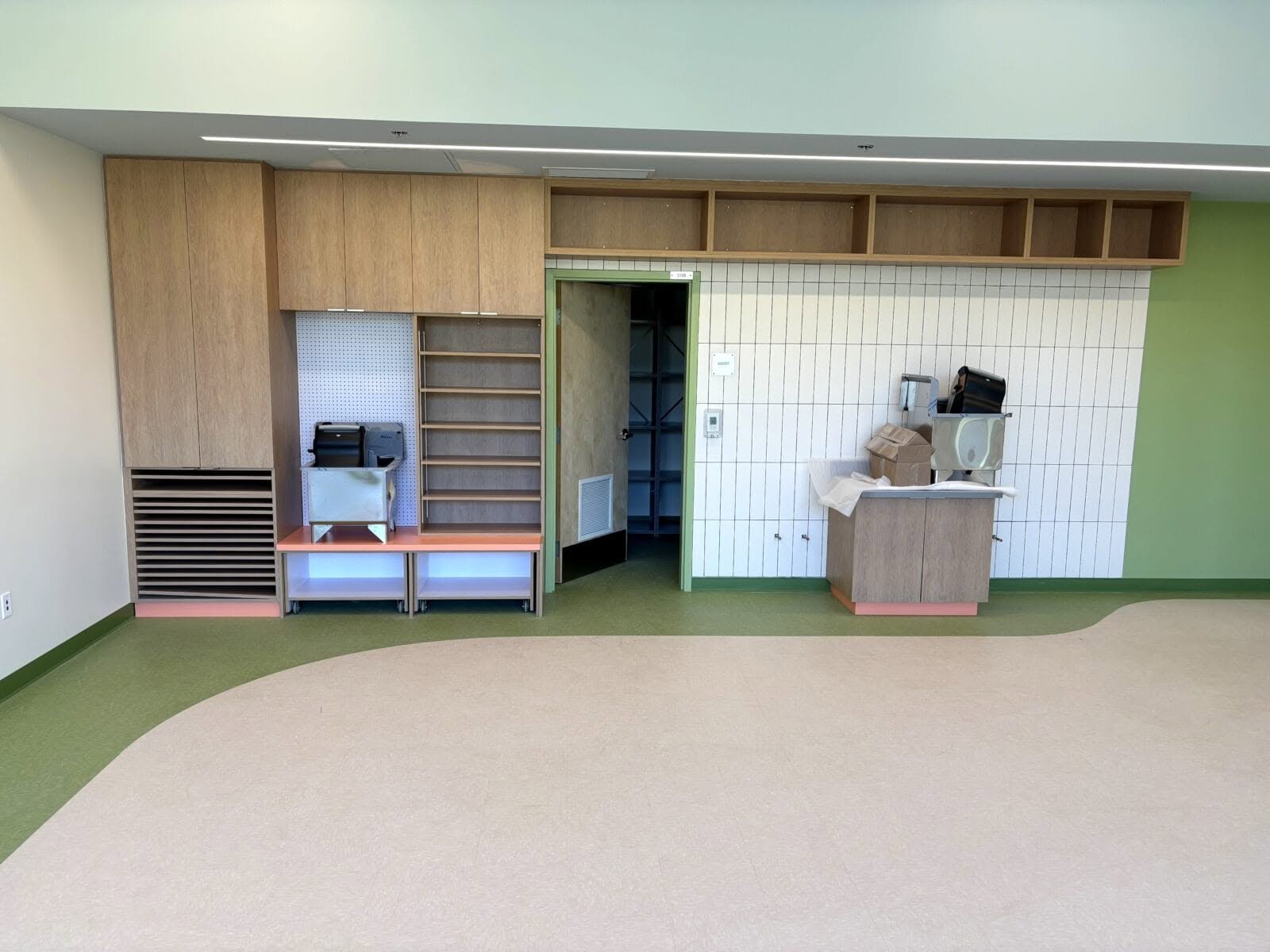 Classroom casework wall with pegboard and LED cubbies